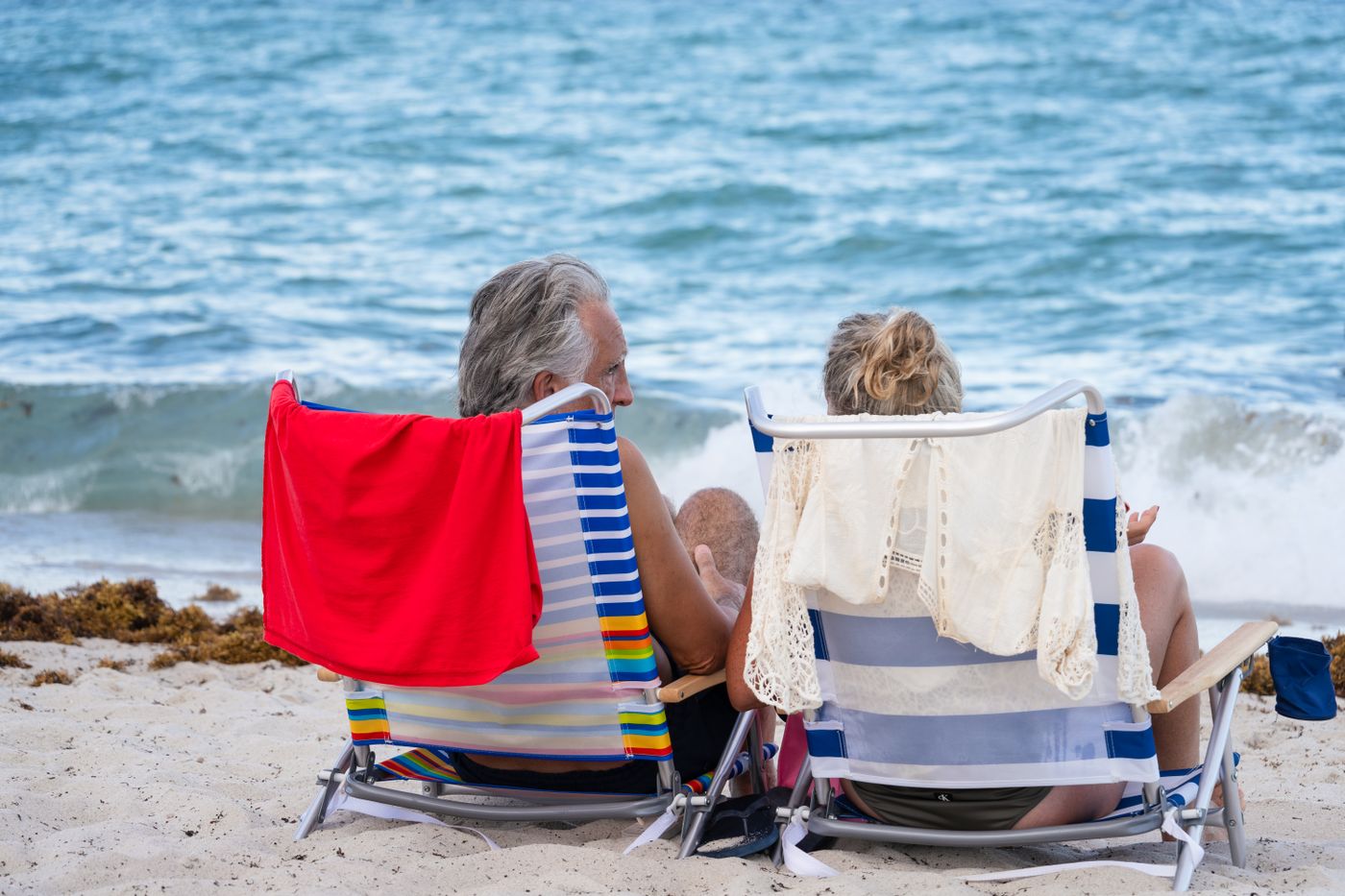 A retired couple relaxing together at the beach