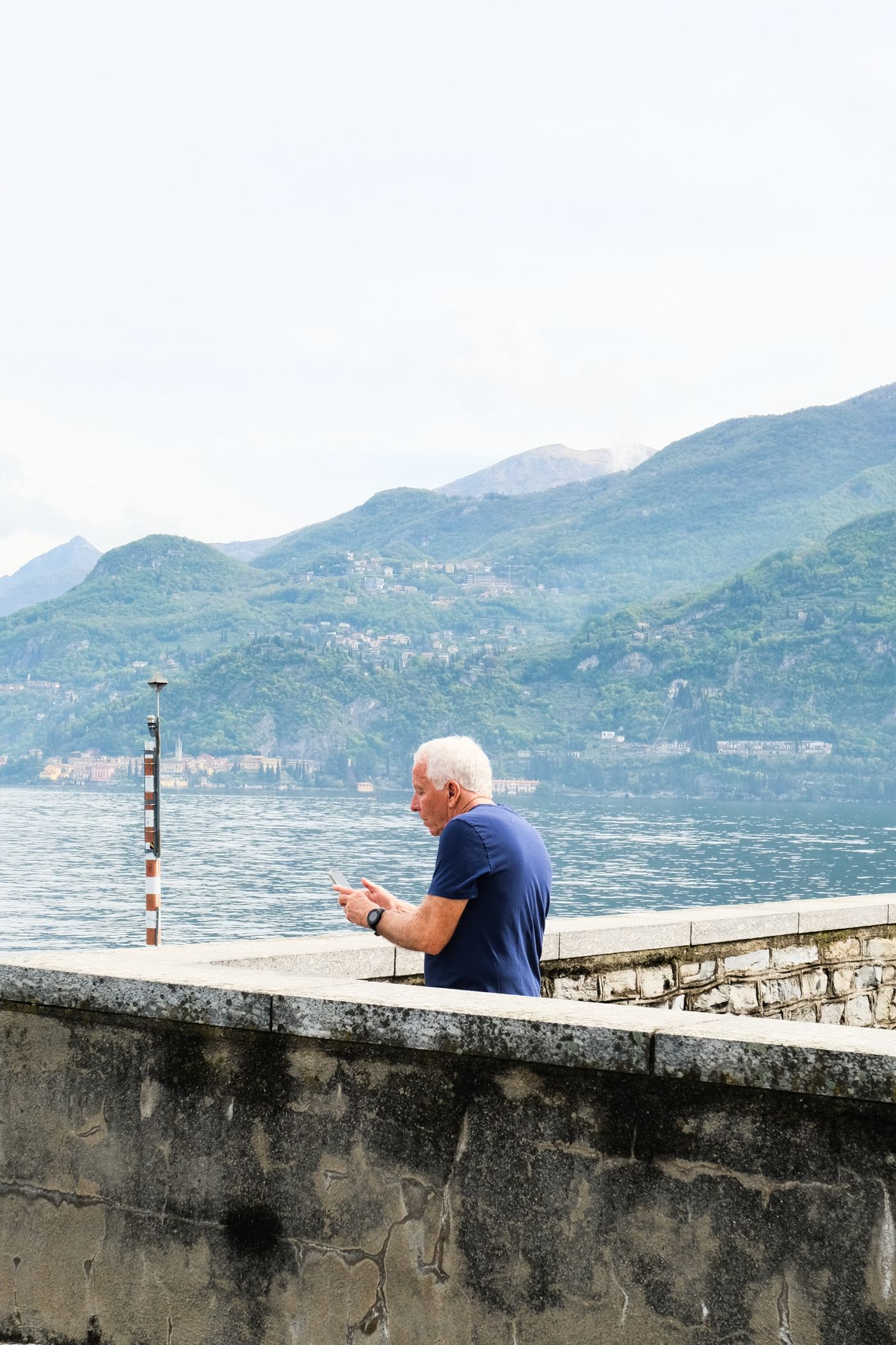 A man taking in a tranquil mountain lake on his own