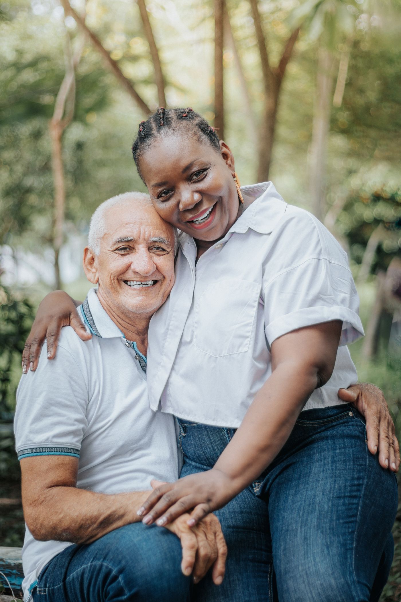 A joyful senior couple embracing in a sunny park